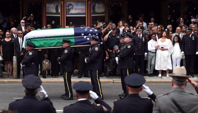 Image: The casket  of  slain New York Police Department (NYPD) Officer Miosotis Familia is carried from the World Changers Church