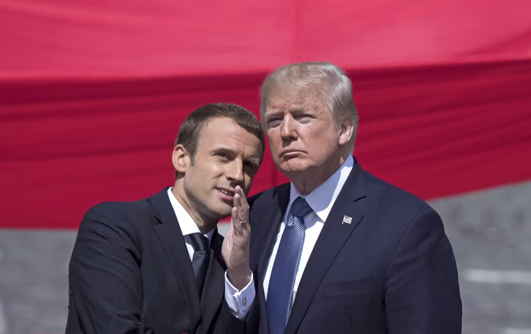 Image: Emmanuel Macron talks to Donald J. Trump during the traditional military parade at Bastille Day celebrations in Paris