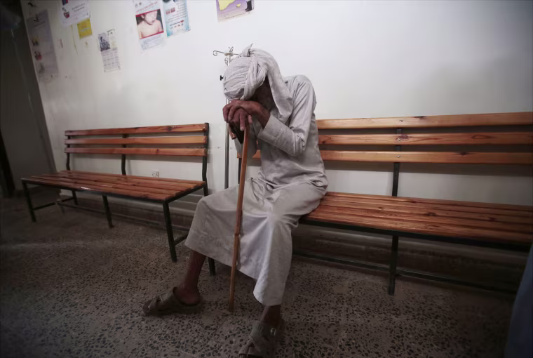 Image: An elderly man waits to be treated for a suspected cholera infection at a hospital in Sanaa