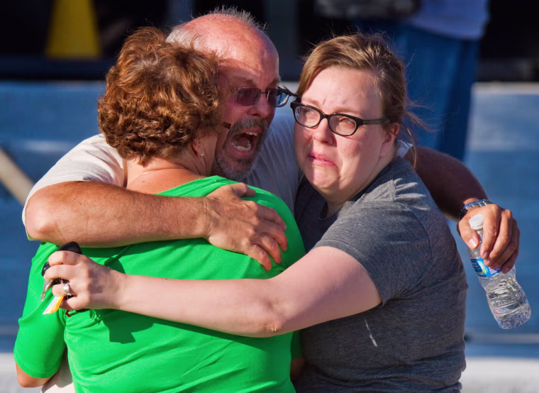 Image: Tom Sullivan embraces family members