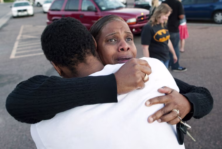 Image: Shamecca Davis hugs her son, Isaiah Bow, a witness to the shooting, outside Gateway High School