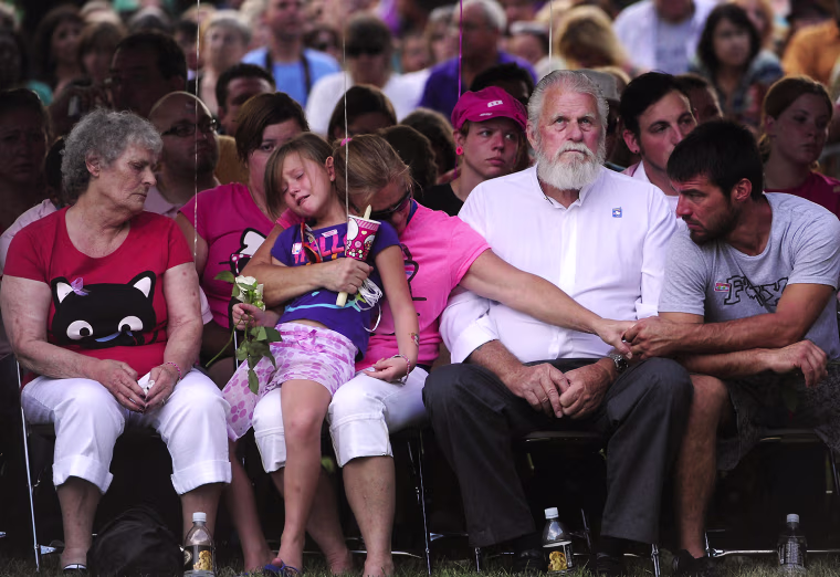 Image: People mourn at a vigil