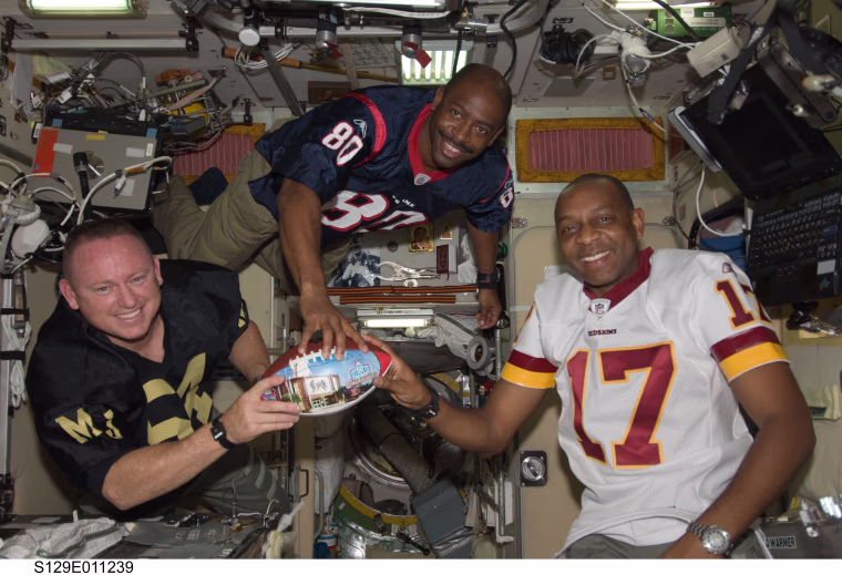 Melvin (center) and crewmates on the ISS. 