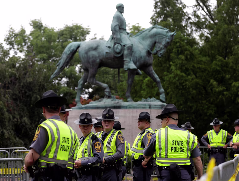 Image: Virginia State Troopers stand under a statue of Robert E. Lee before a white supremacists rally in Charlottesville Virginia
