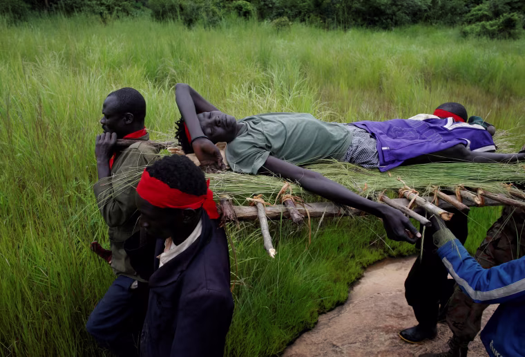 Image: South Sudanese rebels carry an injured rebel after an assault on government forces