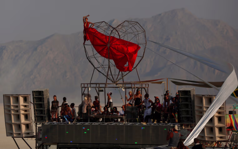 Image: A participant performs during the annual Burning Man festival in the Black Rock Desert of Nevada