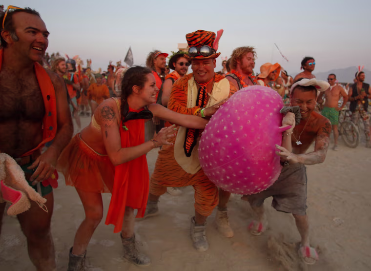 Image: Members of the carrot team try to prevent members of the Bunny March from reaching the Man as approximately 70,000 people from all over the world gathered for the annual Burning Man arts and music festival in the Black Rock Desert of Nevada