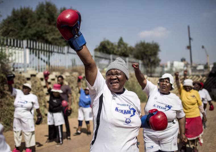 Image: The \"Boxing Gogos\" (Grannies) stretch during a session hosted by the A Team Gym in Cosmo City