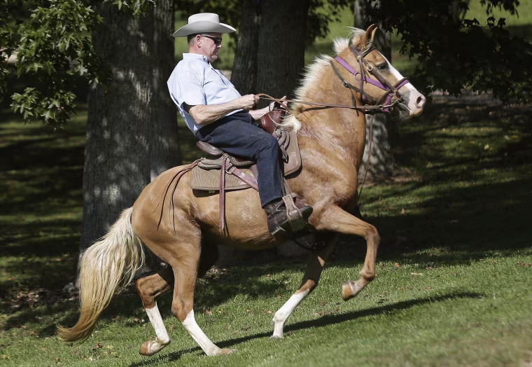 Image: Moore rides in on a horse to vote at the Gallant Volunteer Fire Department during the Alabama Senate race