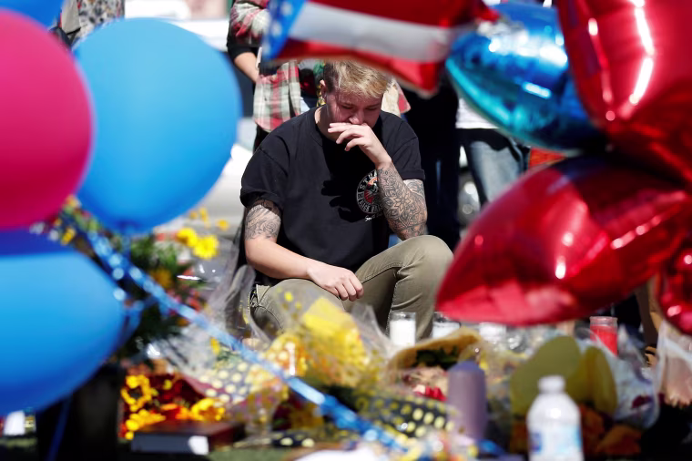 Image: Bry Thompson wipes away tears at a makeshift memorial in the middle of Las Vegas Boulevard following the mass shooting in Las Vegas