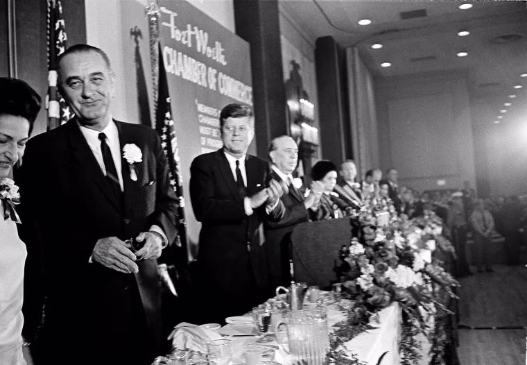 Image: President John F. Kennedy applauds Vice President Lyndon B. Johnson at the Fort Worth, Texas Chamber of Commerce breakfast