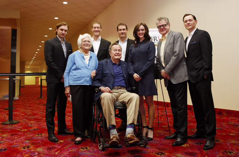 Image: Former President George H.W. Bush poses for a photo with the cast of AMC's series TURN