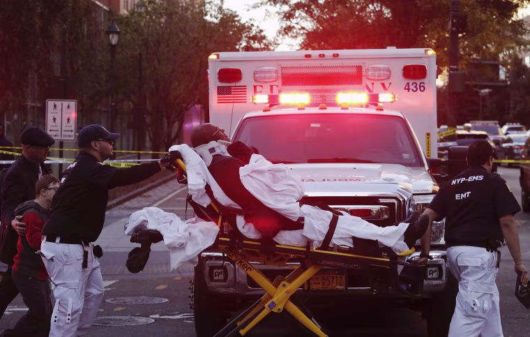 Image: Emergency personnel transport a man on a stretcher