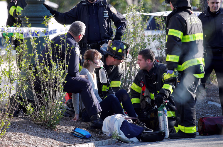 Image: A woman is aided by first responders after sustaining injury on a bike path in lower Manhattan in New York
