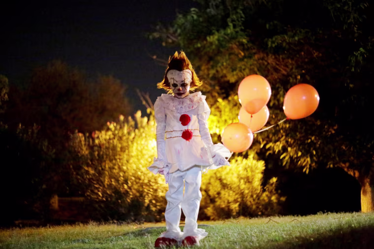 Image: A boy dressed as Pennywise the Dancing Clown from the movie \"It\" poses for a photo during a Halloween party in Ciudad Juarez