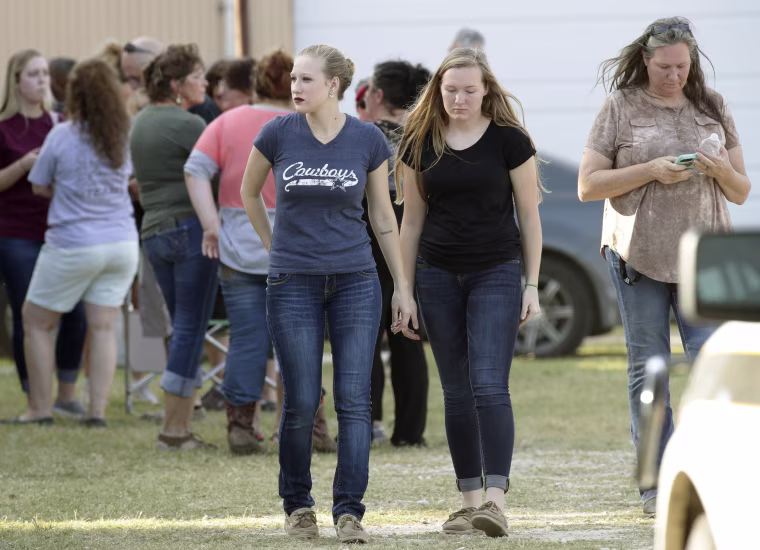 Image: People gather near First Baptist Church following a shooting