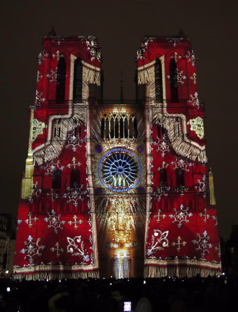 Image: The Notre Dame cathedral is illuminated during a light show called "Dame de Coeur"