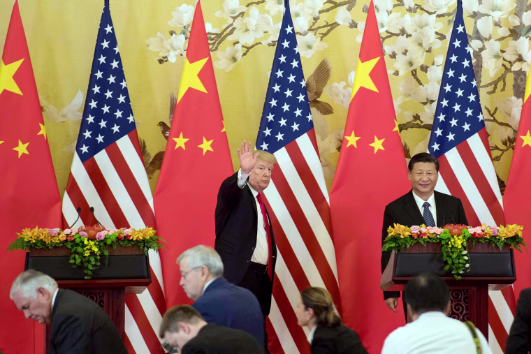 Image: President Donald Trump waves next to Chinese President Xi Jinping after delivering a joint statement