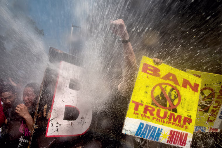 Image: Protesters are soaked as they clash with riot police while marching the streets of Manila during the start of the ASEAN meetings on Nov. 13.