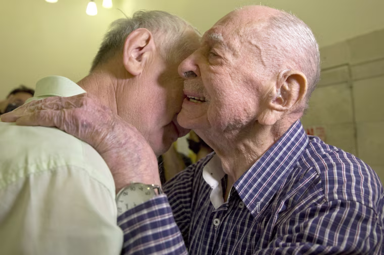 Image: Israeli Holocaust survivor Eliahu Pietruszka, right, embraces Alexandre Pietruszka as they meet for the first time in Kfar Saba on Nov. 16, 2017.