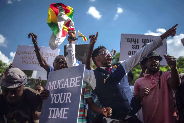 Image:People shout as they gather at Unity square opposite to the Parliament