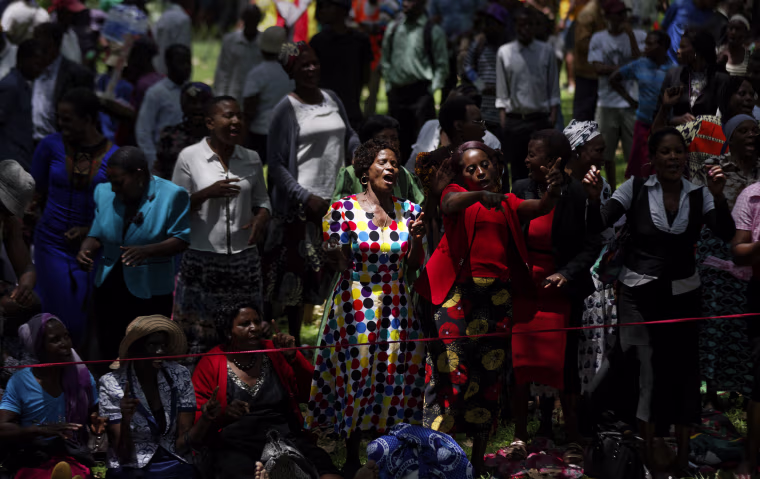 Image: Zimbabweans gather to pray for the country in a park opposite the parliament building