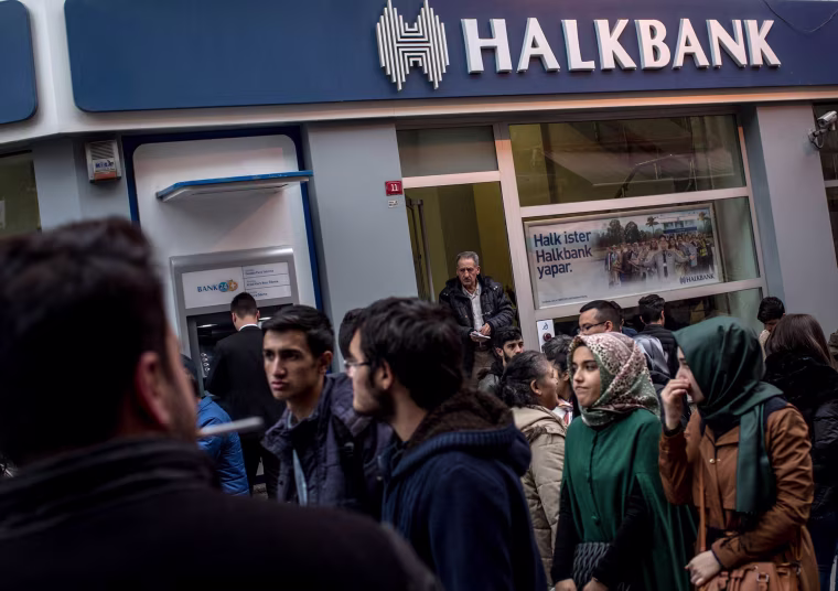 Image: People walk past a branch of the Turkish Halk Bank