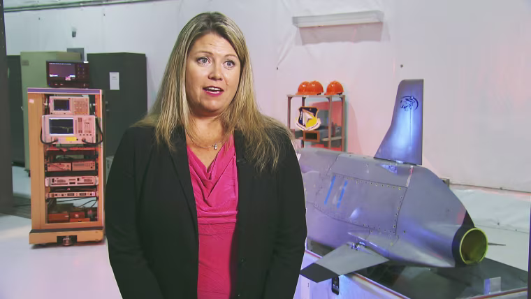 Image: Mary Lou Robinson of the Air Force Research Laboratory explains the CHAMP missile.