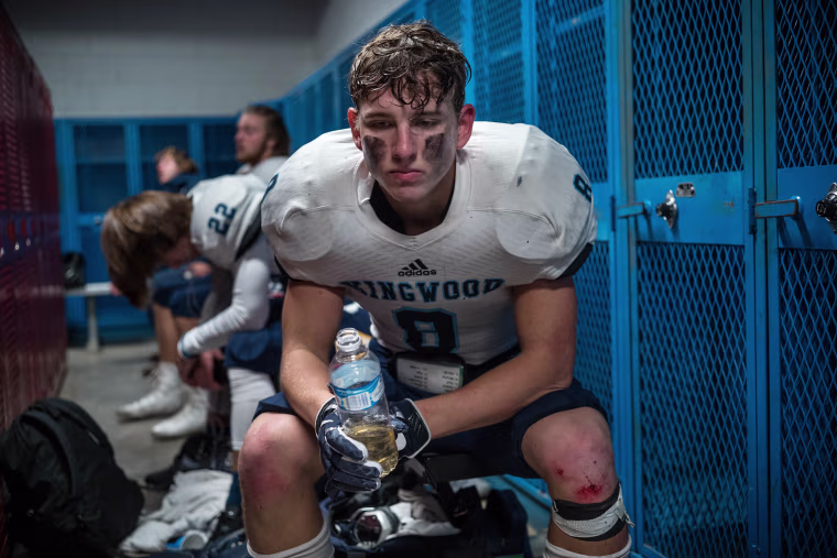 Image: Kingwood's Nolan Powell pauses in the locker room at halftime
