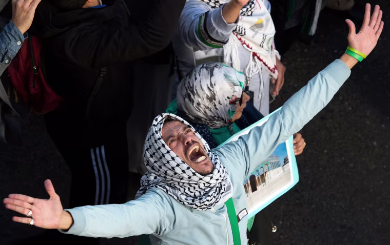 Image: A protester chants slogans against the United States and Israel