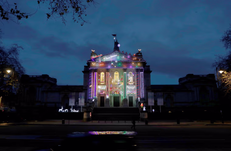 Image: Tate Britain's Christmas art commission, Home for Christmas by Alan Kane, is illuminated on the front of the gallery, in London
