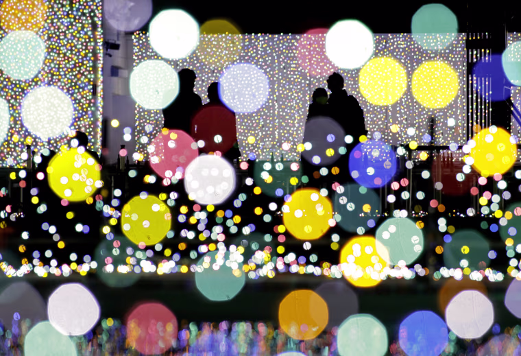Image: Visitors view an illumination show at an amusement park on the outskirt of Tokyo