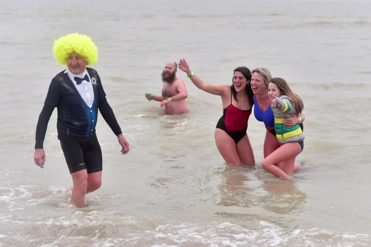 Image: Revellers take part in a New Year's dive in Ostend