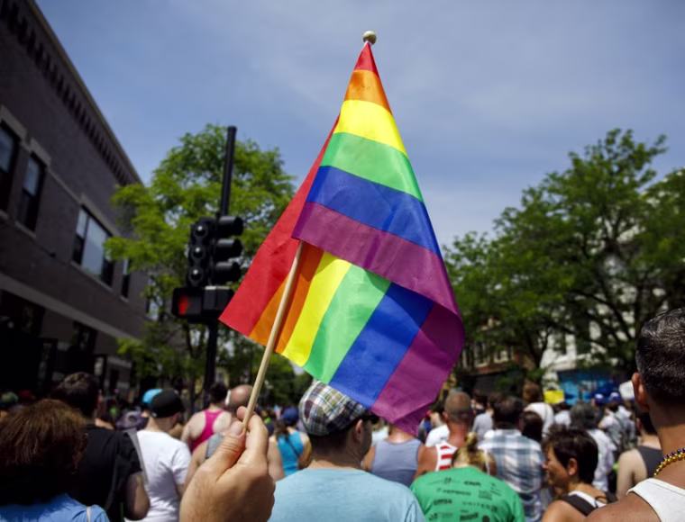 In this June 11, 2017 file photo people attend the LGBTQ Chicago Equality rally in the Andersonville neighborhood of Chicago. 