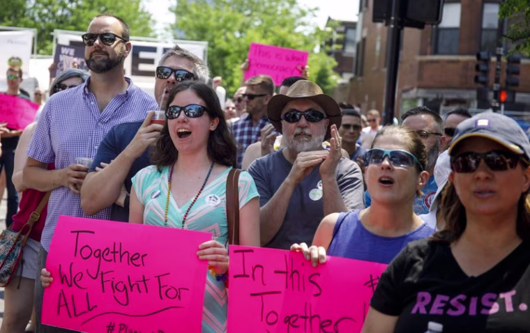 In this June 11, 2017 file photo, people attend the LGBTQ Chicago Equality rally in the Andersonville neighborhood of Chicago. 