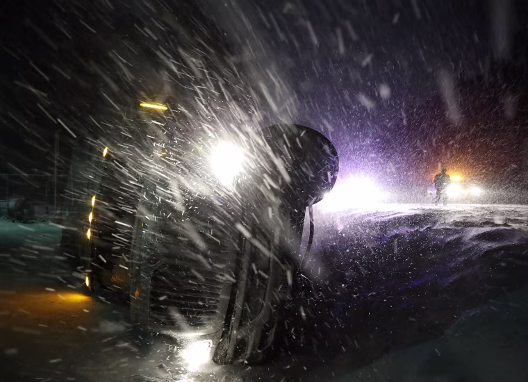 Image: A tractor trailer lays on its side after running off the road during a snowstorm in Georgetown, Delaware
