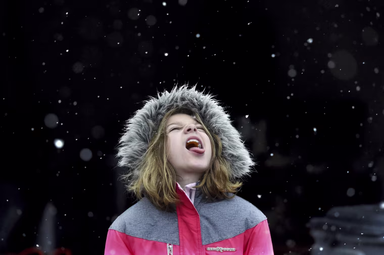 Image: Alison Brown, 9, catches snow flakes on her tongue during a snow storm in Evans, Georgia