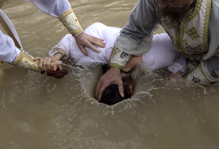 Image: Orthodox Christian pilgrims perform baptisms on Epiphany