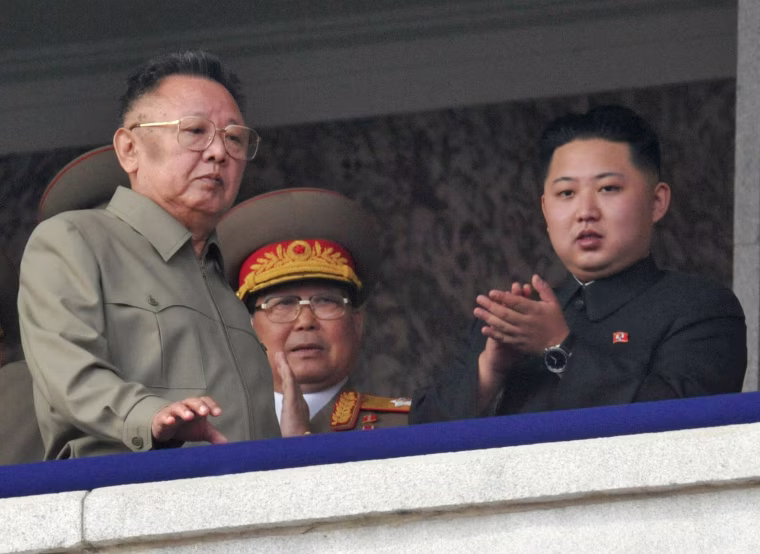 North Korean leader Kim Jong-il (L) walks in front of his youngest son Kim Jong-un (R) as they watch a parade to commemorate the 65th anniversary of the founding of the Workers' Party of Korea in Pyongyang on Oct. 10, 2010.
