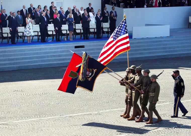 U.S. soldiers wearing World War I helmets march past Macron, his wife Brigitte Macron, President Trump and first lady Melania Trump. This year's Bastille Day parade has dual symbolism: Not only does it celebrate July 14, France's most important holiday, marking the storming of the Bastille prison in 1789, which helped spark the French Revolution. It also commemorates the 100th anniversary of the United States' entry into World War I.