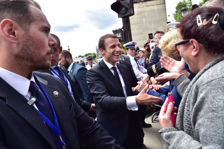 French President Emmanuel Macron meets the crowds following the annual Bastille Day military parade on the Champs-Elysees avenue in Paris on July 14, 2017. The parade on Paris's Champs-Elysees will commemorate the centenary of the US entering WWI and will feature horses, helicopters, planes and troops. / AFP PHOTO / POOL / CHRISTOPHE ARCHAMBAULTCHRISTOPHE ARCHAMBAULT/AFP/Getty Images