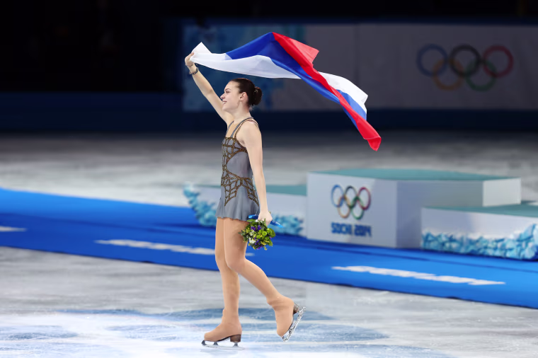 Image: Adelina Sotnikova waves the Russian flag after winning gold