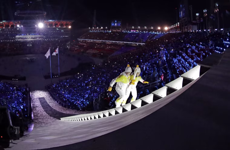 North Korea's Jong Su Hyon, left, and South Korea's Park Jong-ah carry the torch.