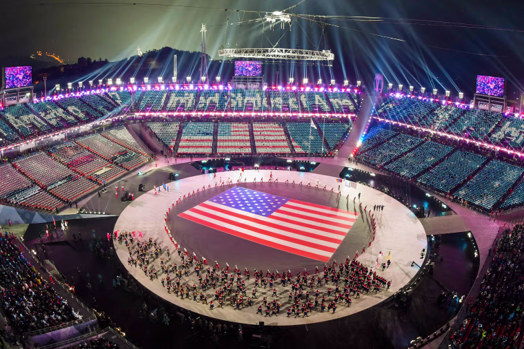 The U.S. delegation parades through the stadium.