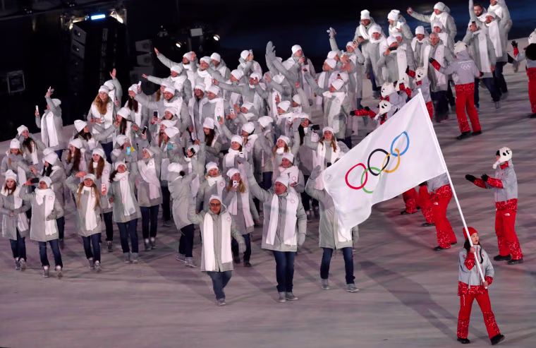 Russian athletes march under a neutral flag. The International Olympic Committee had banned Russia because of a massive doping scheme at the 2014 Sochi Games, but gave individual athletes the chance to apply for admission to compete as \"Olympic Athletes from Russia.\"