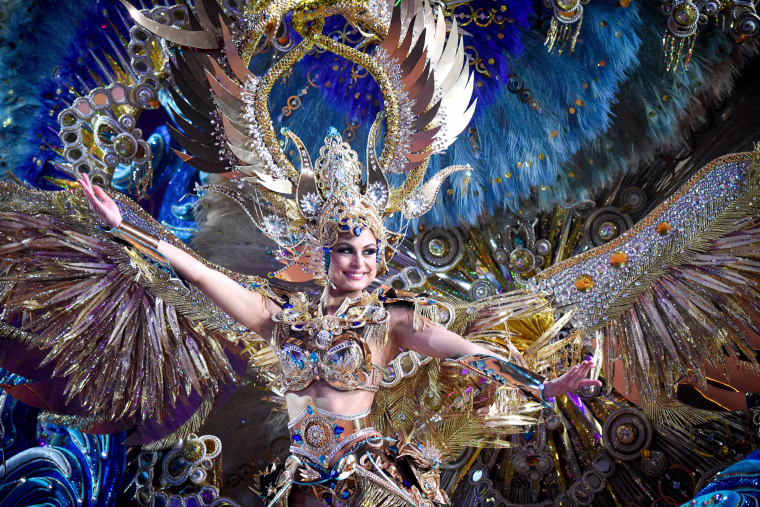 A nominee for queen performs during the main stage of the Carnival of Santa Cruz in Santa Cruz de Tenerife on the Spanish Canary island of Tenerife, on Feb. 07, 2018. The costumes are more than five meters high and over 80 kilos in weight. The event began on January 12 and finishes on February 18 with orchestras playing Caribbean and Brazilian rhythms throughout the festivities that range from elections for the Carnival Queen, the Junior Queen and the Senior Queen, to children and adult murgas (satirical street bands), comparsas (dance groups) and street performances.
