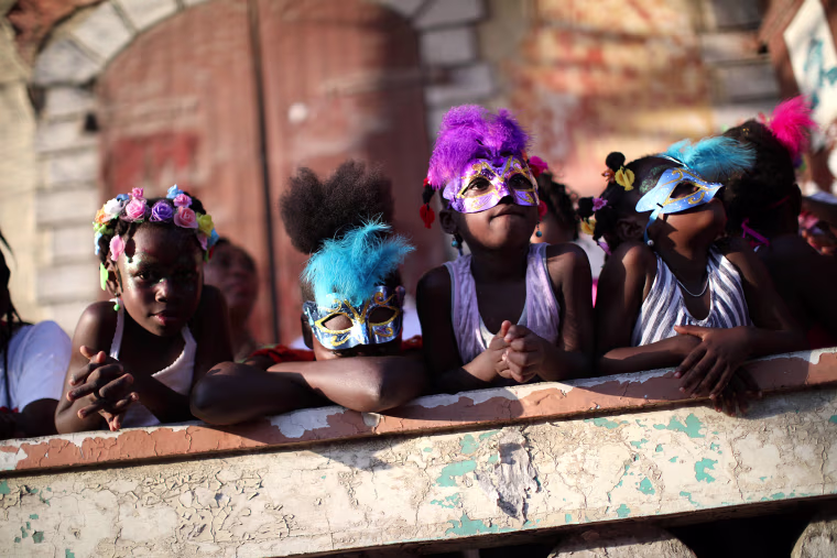 Girls attend a parade along a street at the Carnival of Jacmel, Haiti, Feb. 4, 2018.