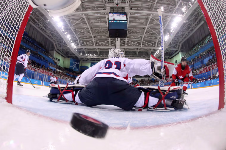 Switzerland's Alina Muller (25) scores a goal against Unified Korea's goalie, Shin So-jung (31), during the women's preliminary round ice hockey match between Switzerland and the Unified Korean team on Feb. 10.