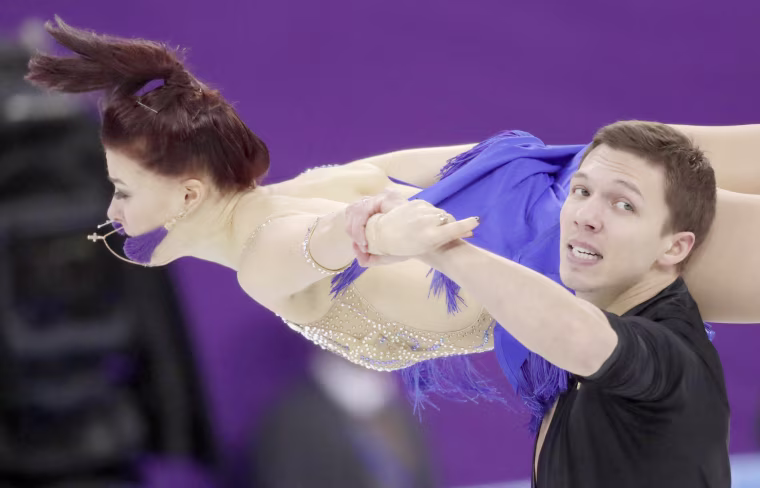 Russian athletes Ekaterina Bobrova and Dmitri Soloviev perform during the ice dance short dance team event on Feb. 11.
