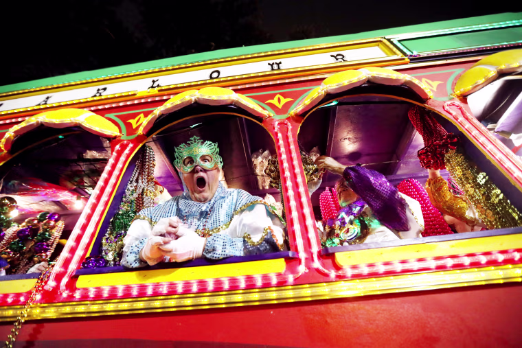 Image: Float riders encourage the crowd as the Krewe of Orpheus rolls through New Orleans